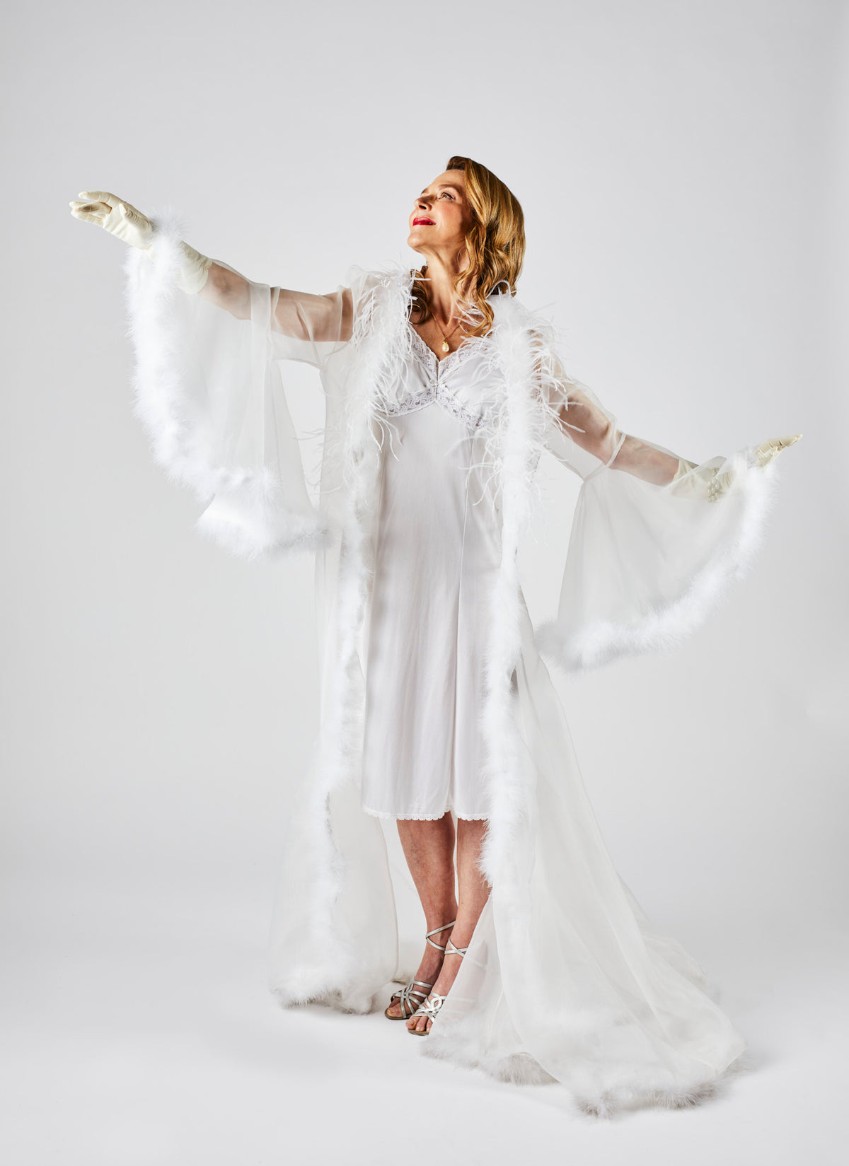 Wide angle image of wealthy woman wearing a white silk gown from video production company Enamoured Iris