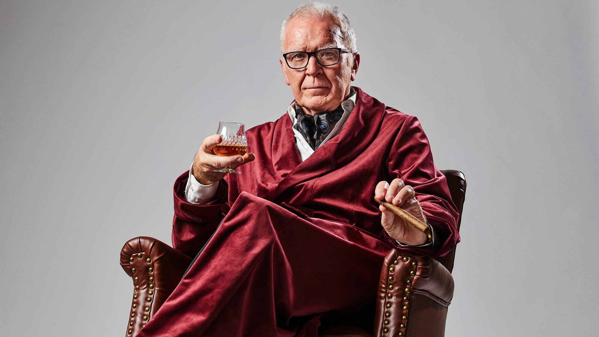 Executive Producer wearing an Enamoured Iris video production robe while holding a class of scotch and a cigar