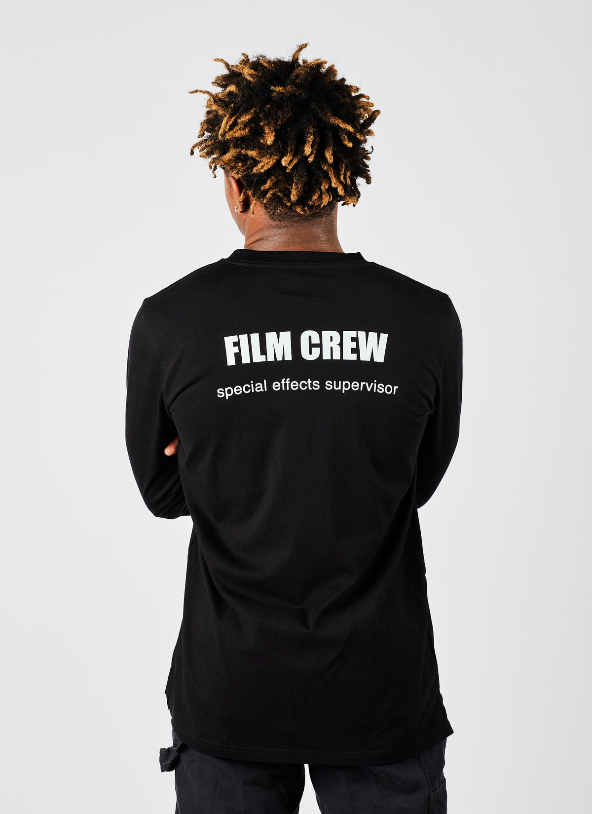 Back of a male wearing a black, long-sleeved &quot;Special Effects Supervisor&quot; shirt from video production company, Enamoured Iris.