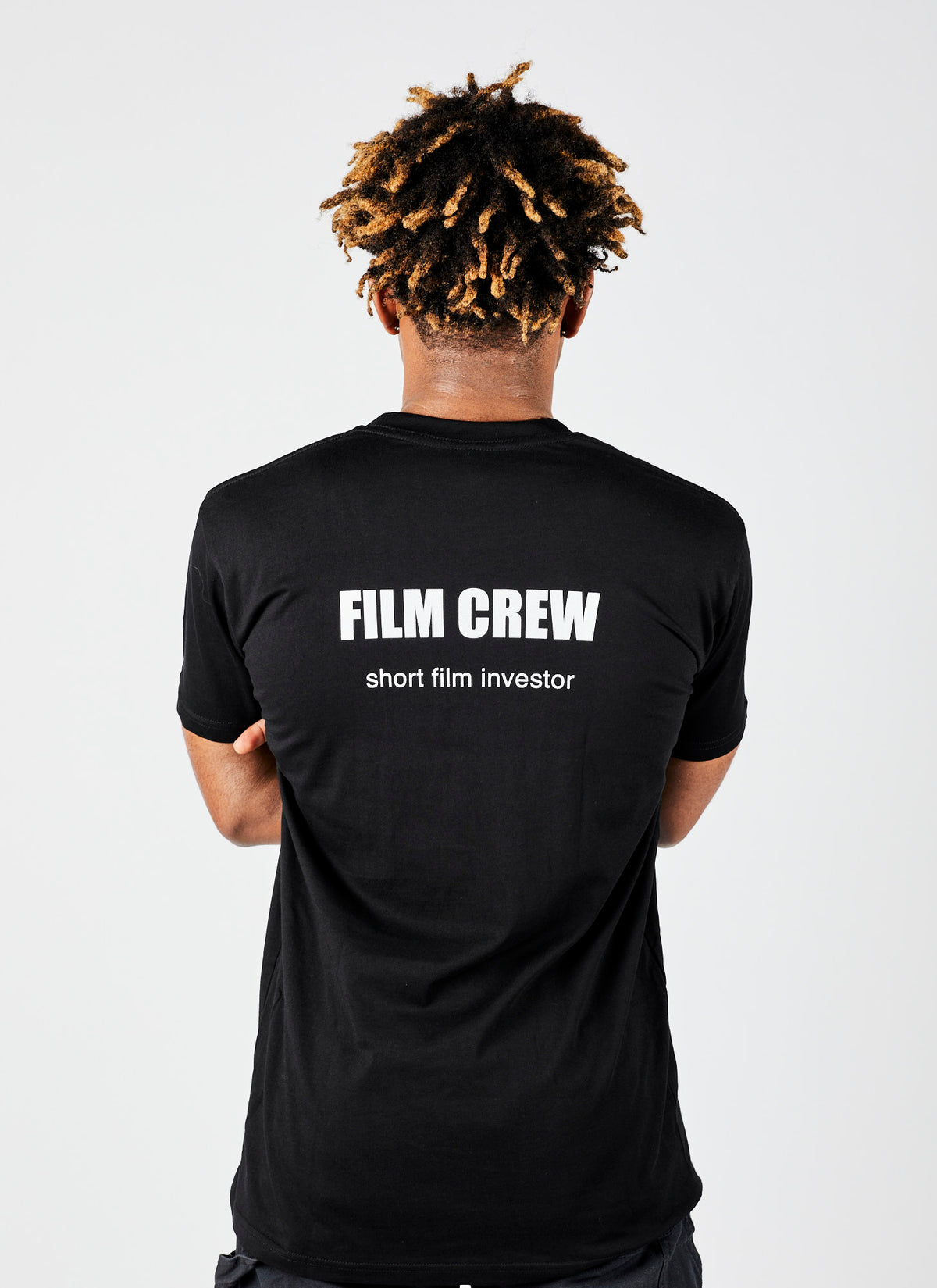 Reverse of a male wearing a black &quot;Short Film Investor&quot; shirt from a video production company in Melbourne